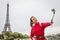 Woman taking selfie at Eiffel Tower