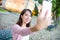 Woman taking selfie by mobile phone in Macau