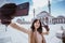 woman taking selfie portrait in front of the mosque in konya