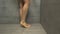 Woman taking shower. Close up of female legs in bathroom. Beautiful slim female legs in shower, side view