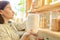 Woman taking storage jar with flour from shelves