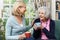 Woman Taking Time To Visit Senior Female Neighbor And Talk