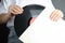 Woman taking vinyl record out of paper sleeve on grey, closeup