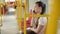 Woman talk to smartphone in the public transport, girl talking on the phone in the urban bus