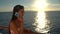 Woman talking on phone on Cruise ship vacation enjoying sunset at sea