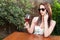 Woman talking at phone raising glass of wine