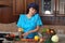 Woman talking on the phone and rubs carrots on a grater