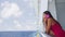 Woman talking on smartphone having phone conversation on cruise ship