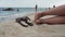 Woman tanned legs on sand beach.
