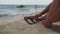 Woman tanned legs on sand beach. Travel concept.