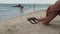 Woman tanned legs on sand beach. Travel concept.