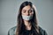 Woman, tape and mouth with silence for protest, social activism and fight against covid 19 by background. Human rights