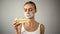 Woman with taped mouth looking at cake, fighting temptation to eat pie, diet