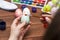A woman with a tassel paints Easter eggs. Preparing decorations for Easter, creativity with children, traditional symbols.