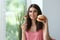 Woman with tasty burger and fork with sliced vegetables indoors. Choice between healthy and unhealthy food