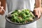 Woman with tasty pear salad on light background, closeup