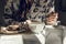 Woman with tea cup, and chocolate donut, sitting at the table. b