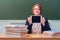Woman teacher sits at a table with a tablet in her hands, copy space. Online education at school and university
