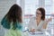 Woman teacher talking to teenage girl, education, social assistance, adolescence