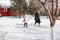 Woman teaches child to clean carpet. Family is engaged in traditional method of ecological carpet cleaning with help of