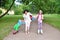 A woman teaches to make the first steps on roller skates childre