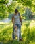 Woman teaching adorable smart dog Australian Shepherd new commands during obedience training in nature