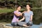 Woman teaching yoga outdoor in a lake