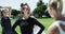 Woman, team and soccer captain stretching before match, game or getting ready on green grass field. Female person