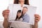 Woman Tearing Photo Of Happy Couple