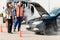 Woman with technician help smoking car engine