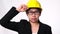 Woman technician smiling with helmet. Confident woman construction worker on white background in studio.