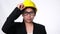 Woman technician smiling with helmet. Confident woman construction worker on white background in studio.