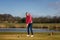 Woman teeing off at a golf course