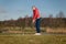 Woman teeing off at a golf course