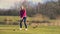 Woman teeing off at a golf course