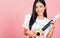 Woman teen confident smiling face hold acoustic Ukulele guitar
