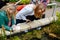 Woman and teen girl exploring botanical garden pond