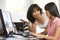 Woman And Teenage Daughter Using Computer