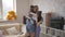 A woman with teenage daughters in the process of assembling furniture in the living room.