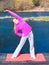 Woman teenage girl in tracksuit doing exercise on pier outdoor