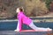 Woman teenage girl in tracksuit doing exercise on pier outdoor