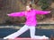 Woman teenage girl in tracksuit doing exercise on pier outdoor