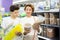 Woman with teenage son selecting food for turtles in pet store