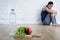 Woman or teenager girl sitting on ground alone worried at home