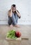 Woman or teenager girl sitting on ground alone worried at home suffering nutrition eating disorder