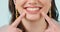 Woman, teeth and smile pointing closeup with cosmetics, dental hygiene and veneers in studio. Dentist work, female