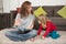 Woman telling a story to child sitting on carpet