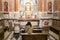 A woman in a temple prays to God. Woman praying in front of altar. Praying woman in front of altar. selected focus