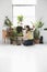 Woman tending potted plants by window