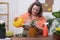 A woman tending to her plants with care and attention, using a watering can to hydrate them